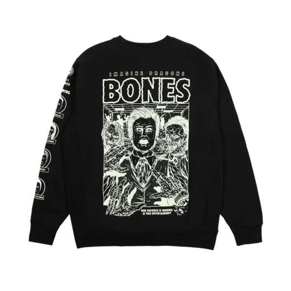 Black Imagine Dragons Bones crewneck sweatshirt featuring a horror themed graphic design The design includes bold text BONES with IMAGINE DRAGONS above it an eerie illustration of a suited man with skeletal hands and ghoulish figures and the phrase OUR PATIENCE IS WANING IS THIS ENTERTAINING at the bottom The left sleeve has multiple circular logos