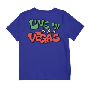 A royal blue Imagine Dragons T-shirt featuring a bold graphic on the back with the words "Live 'N Vegas" in green and red, accompanied by three yellow stars. The design has a vibrant, playful look, making it a standout merch piece for fans.